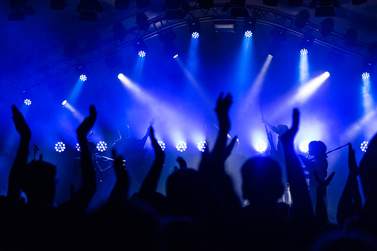 Mastering the First Impression: Your intriguing post title goes here Dynamic concert scene with cheering crowd and vibrant blue lighting.